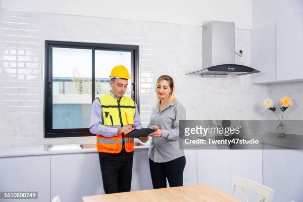 a house inspector checking a quality of the kitchenware in a new house - counter surface level stock pictures, royalty-free photos & images