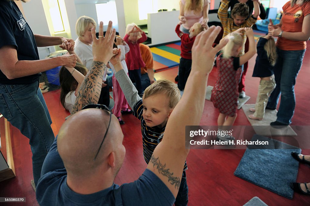 (HR) ABOVE: Mike Morelock dances in class with his son Asher, 4. The Anchor Center specializes in helping blind and visually impaired children from infancy to age 5. The new facility near Stapleton was designed with these children in mind. Specialized lig