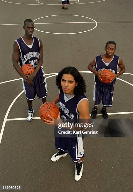 Abraham Lincoln High School basketball players Ruot Pal, left, Jorge Gutierrez, center, and Kadeem Thomas, right.