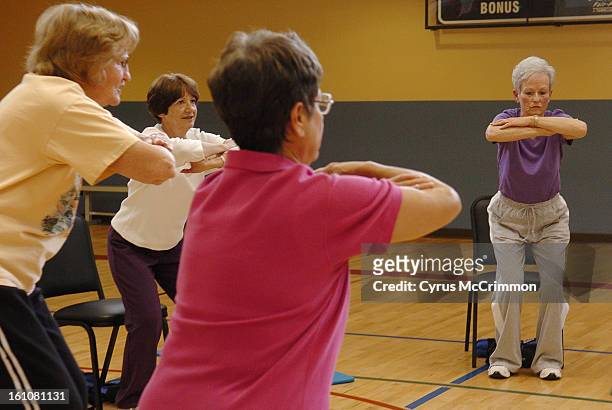 Left to right Betty Bingham, Jill Gillett, Sylvia Rushforth and Cathy Moran hold a pose during the workout class called "Strong Women Strong Bones"...