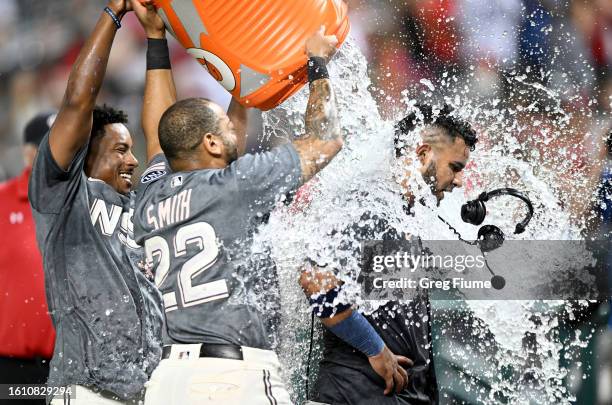 Keibert Ruiz of the Washington Nationals is doused with water by Dominic Smith and Jeter Downs after hitting the game-winning home run in the ninth...