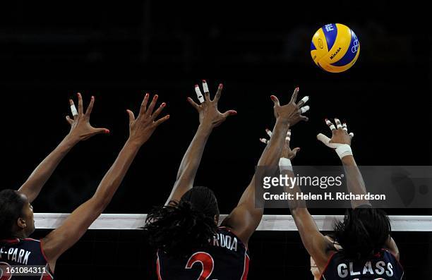 S Tayyiba Haneef_Park ,left, Danielle Scott-Arruda, and Kimberly Glass, right go up for a block. The U.S. Women's volleyball team won the silver...
