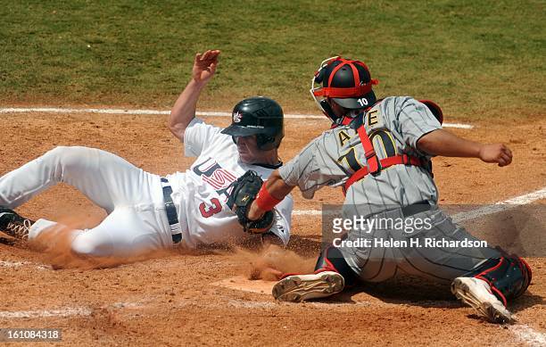 S Jayson Nix, of the Colorado Rockies farm system gets tagged out at homeplate by Japan's catcher Shinnosuke Abe. Fueled by a four-run rally in the...