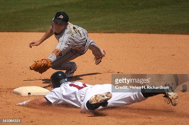 Japan's second baseman Masahiro Araki tries to tag USA's Matt Brown out a second. He was called safe. Fueled by a four-run rally in the fifth inning,...
