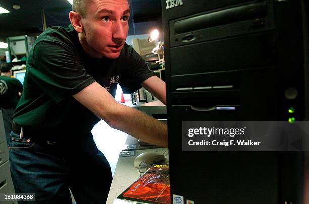 2006__Olivier Gerber, lead technician at Action Computers, inc. In Denver, CO, works on an IBM computer. The computer had been dropped off to have a...