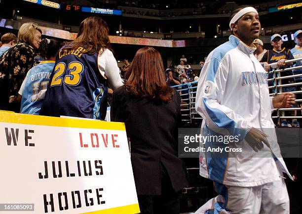 Carmelo Anthony rounds a sign showing fan support for Julius Hodge, who was shot early Saturday morning near I-76 and I-25. The Nuggets were playing...