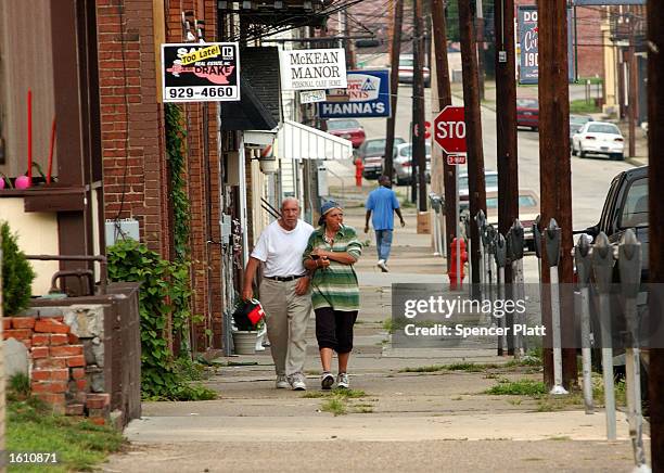 Peolple walk the deserted streets August 26, 2001 of Donora, Pennsylvania. Donora, a struggling town in the steel and coal belt of western...