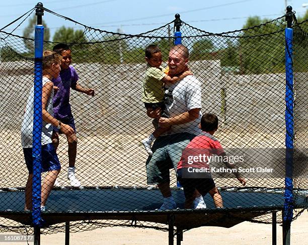 After working all morning at the Casa de la Nueva Vida<cq> orphanage, Spencer<cq> Rich<cq> takes time to play with some of the kids before lunch.