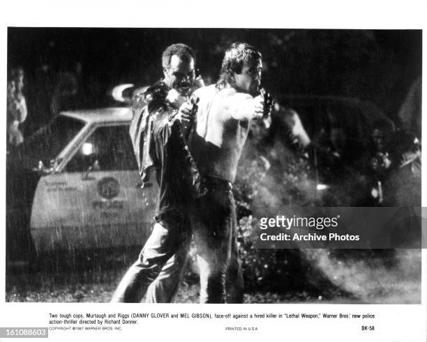 Danny Glover and Mel Gibson shoot out in a scene from the film 'Lethal Weapon', 1987.