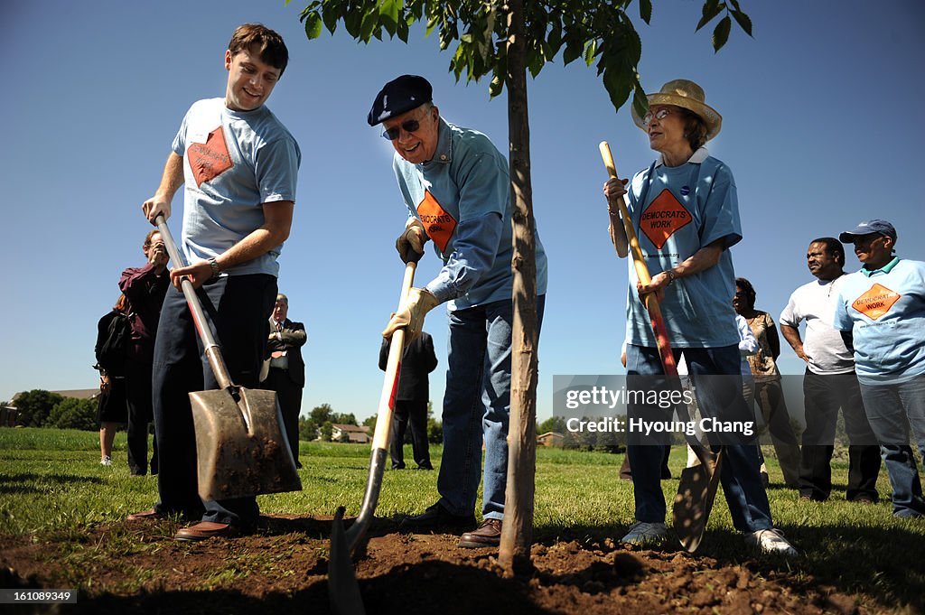 (HC) DNC28carter_ Former president Jimmy Carter, center, and his wife Rosalyn, right, and their grand son Jason are tree planting during their participating in the day service with the Georgia Delegation at Bicentennial Park in Aurora on Wednesday. Denver