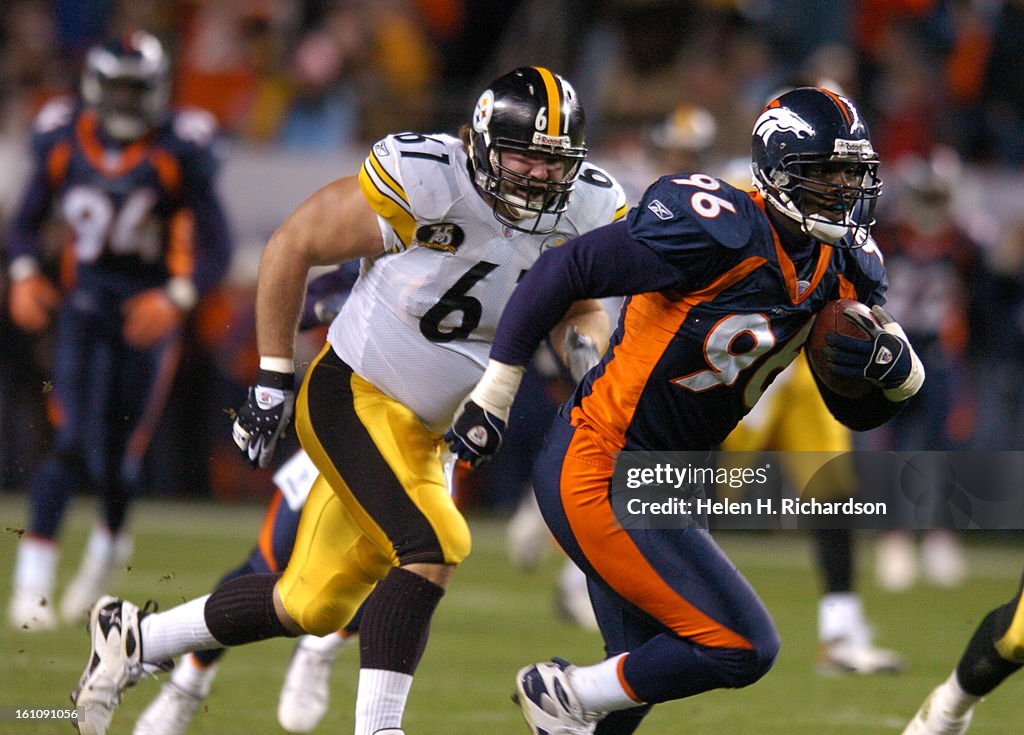 BRONCOS_STEELERS Denver Broncos defensive end Tim Crowder picks up a loose ball fumbled by Pittsburgh Steelers quarterback Ben Roethlisberger and returns it for a touchdown in the second quarter. The fumble was caused by the Broncos other defensive end El