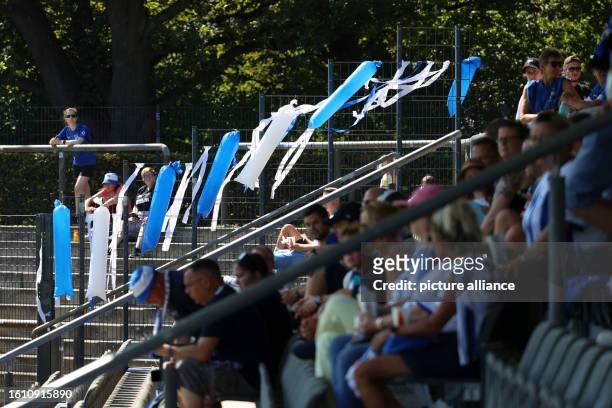 August 2023, Berlin: Regionalliga women: Hertha BSC - Union Berlin. A fence at Hanns-Braun-Stadion is decorated in blue and white colors ahead of the...