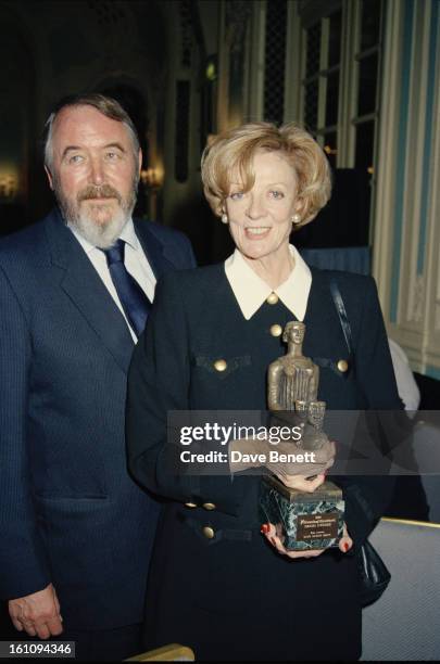 English actress Maggie Smith , winner of the Best Actress award for "Three Tall Women" poses with her husband, playwright Beverley Cross , at the...