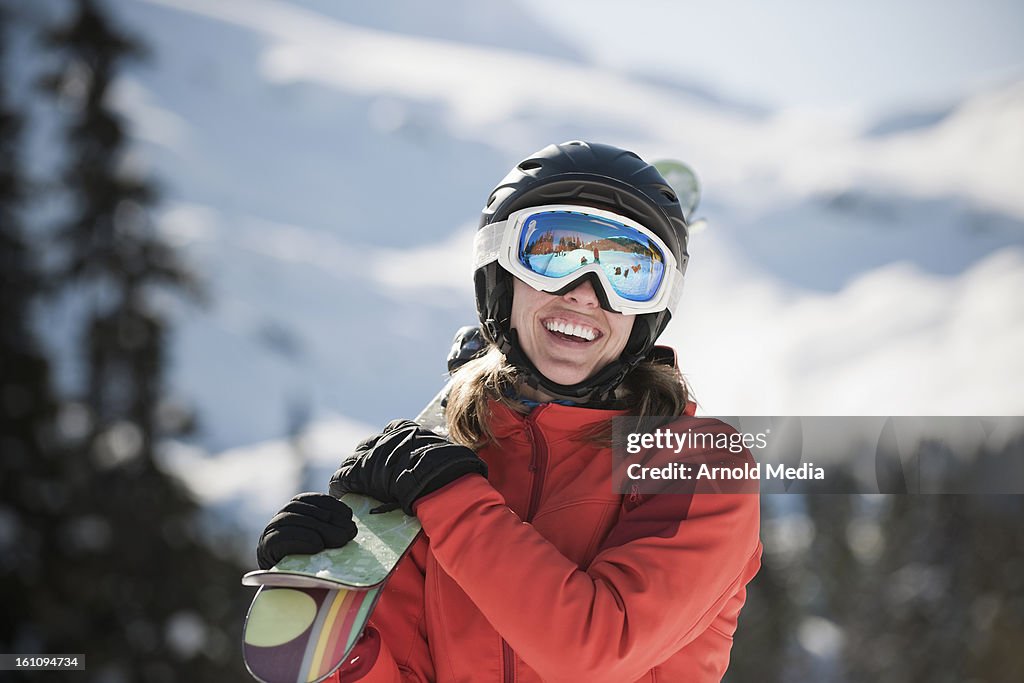 Woman carrying skis