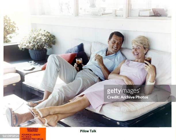 Rock Hudson and Doris Day relax on set of the film 'Pillow Talk', 1959.