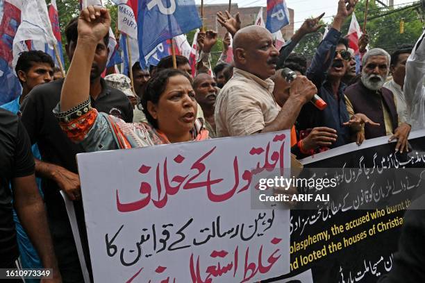 Christians shout slogans as they hold placards during a protest in Lahore on August 20 to condemn the attacks on churches in Pakistan. More than 80...