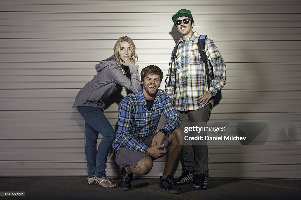 Friends posing infront of a garage.