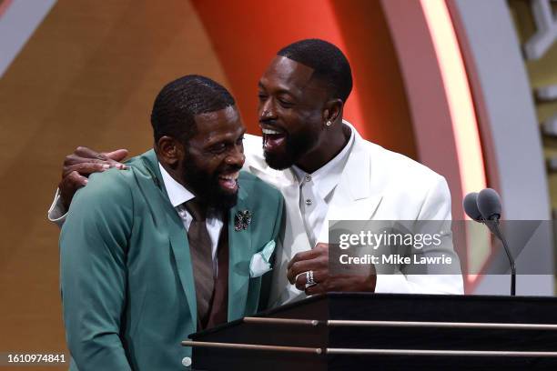 Inductee Dwyane Wade speaks on stage with his father Dwyane Wade Sr. During the 2023 Naismith Basketball Hall of Fame Induction at Symphony Hall on...