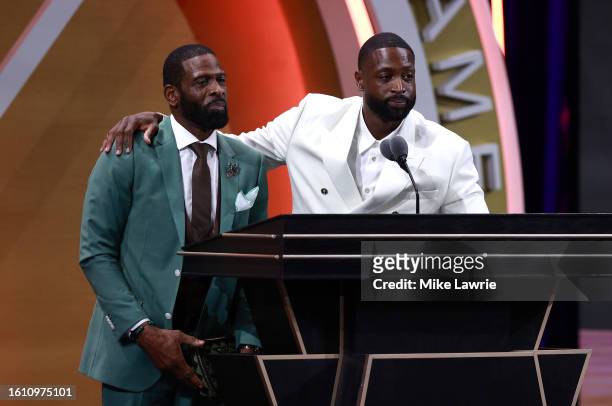 Inductee Dwyane Wade speaks on stage with his father Dwyane Wade Sr. During the 2023 Naismith Basketball Hall of Fame Induction at Symphony Hall on...