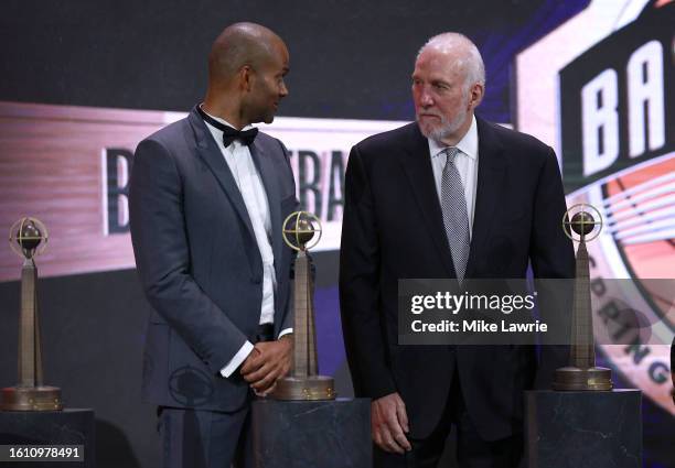 Inductees Tony Parker and Gregg Popovich react on stage during the 2023 Naismith Basketball Hall of Fame Induction at Symphony Hall on August 12,...