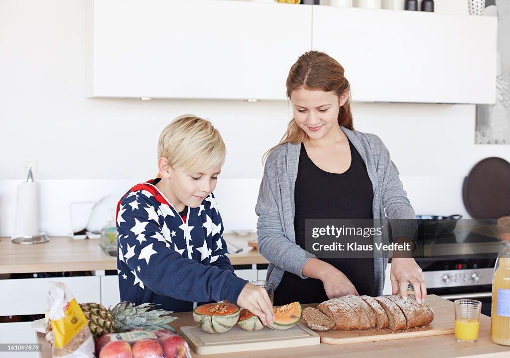 Siblings doing healthy breakfast in kitchen