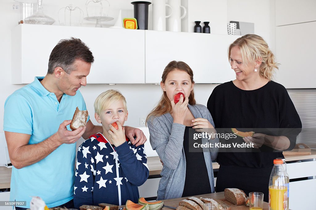 Family eating healthy breakfast in kitchen