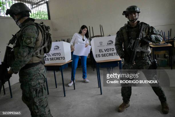 Ecuador's presidential candidate for the Revolucion Ciudadana party, Luisa Gonzalez, votes under heavy security at a polling station in Canuto,...