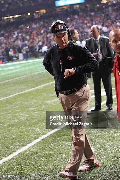 Head Coach Jim Harbaugh of the San Francisco 49ers checks his watching while the lights were at during Super Bowl XLVII against the Baltimore Ravens...