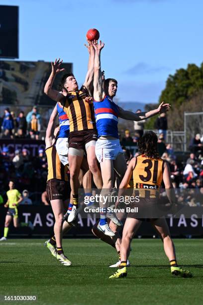 Tim English of the Bulldogs and Mitch Lewis of the Hawks compete for the ball during the round 22 AFL match between Hawthorn Hawks and Western...