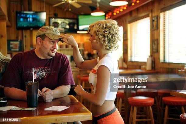 Michael Boling 37 of Broomfield talks with one of his favorite Hooters girls, Sammy Williams at his favorite hang out. Boling who has a ruptured a...