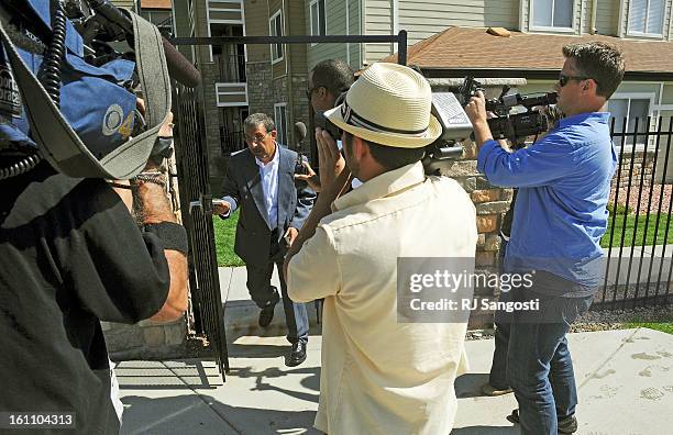 Mohammed Zazi, the father of Najibullah Zazi, waves off reporters as he leaves his son's apartment to move a car, at the Vistas apartment complex in...