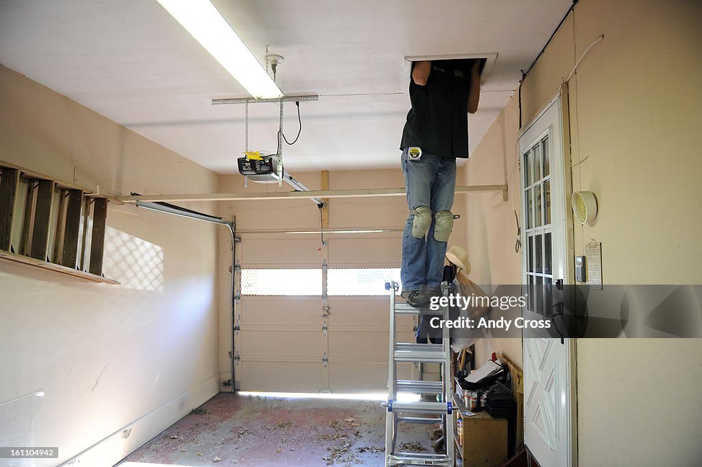DENVER, CO--NOVEMBER 23RD 2010-- U.S. Army veteran, 1st Armored Division, Josh Kemp, served several tours in Iraq, now working for Veterans Green Jobs, Weatherization Services, heads up into client, Alice Litzsinger's attic to check insulation during an e