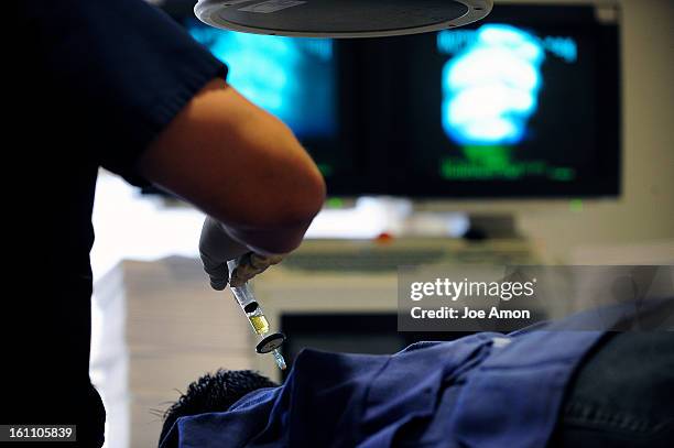 Dr . Chris Centeno using platelet rich plasma during a prolotherapy session at the Centeno-Schultz Clinic in Broomfield. Joe Amon, The Denver Post