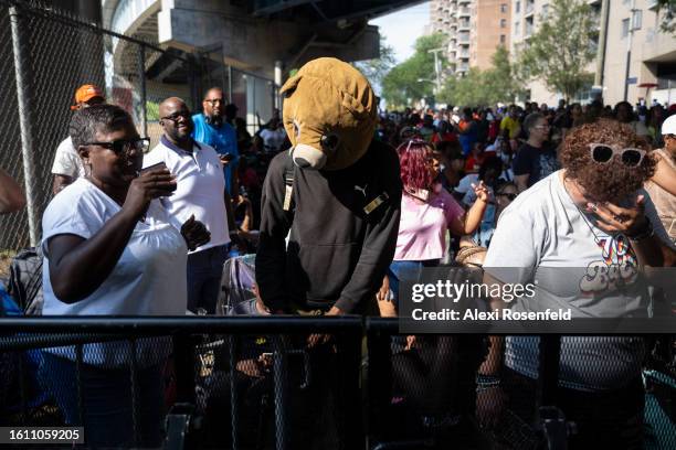 Person wearing a teddy bear costume mask while dancing in the crowd at the fiftieth anniversary of Hip Hop block party near 1520 Sedgwick Ave on...