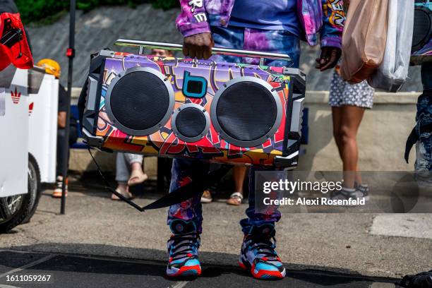 Person holds a boom bos at the fiftieth anniversary of Hip Hop block party near 1520 Sedgwick Ave on August 12, 2023 in The Bronx borough of New York...