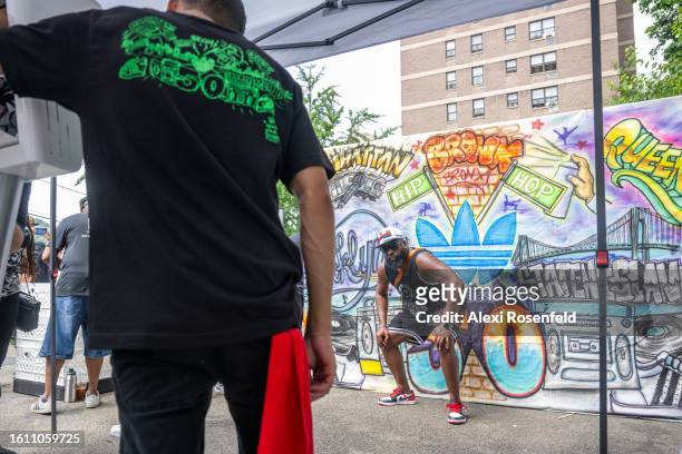 Person poses with a bronx backdrop at the fiftieth anniversary of Hip Hop block party near 1520 Sedgwick Ave on August 12, 2023 in The Bronx borough...