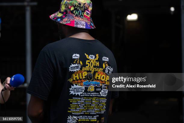 Person wearing a 50th anniversary of Hip Hop tee shirt attends the fiftieth anniversary of Hip Hop block party near 1520 Sedgwick Ave on August 12,...