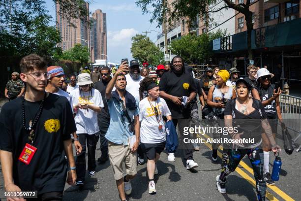 One interacts with people at the fiftieth anniversary of Hip Hop block party near 1520 Sedgwick Ave on August 12, 2023 in The Bronx borough of New...
