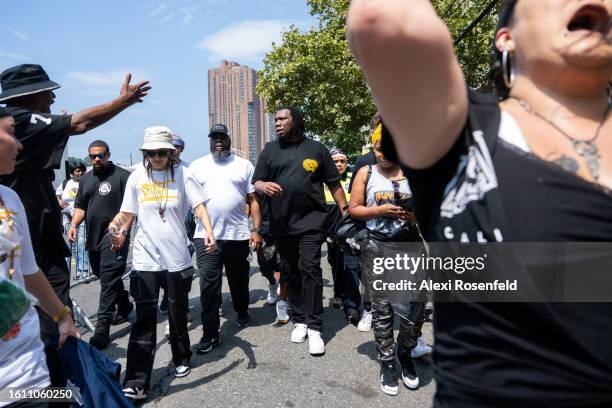 One interacts with people at the fiftieth anniversary of Hip Hop block party near 1520 Sedgwick Ave on August 12, 2023 in The Bronx borough of New...