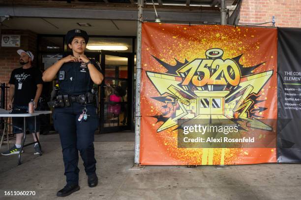 Officer stands outside of the 1520 Sedgwick Ave building where murals are displayed at the fiftieth anniversary of Hip Hop block party on August 12,...