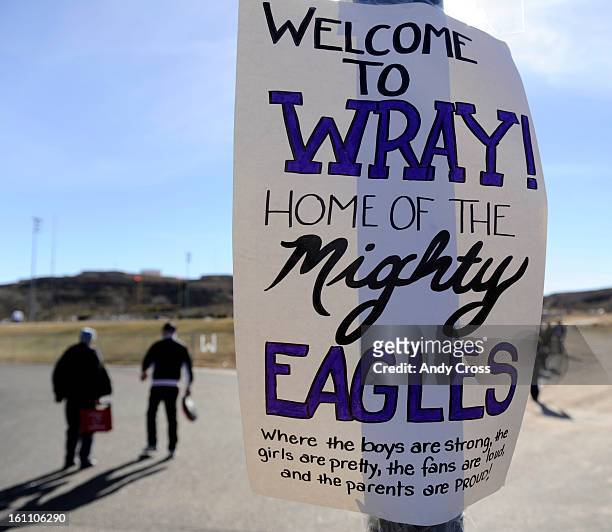 Sign greets Wray High School football fans that states "Where the boys are strong, the girls are pretty, "the fans are loud, and the parents are...