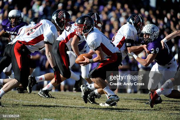Burlington QB, Spencer Cure, looks to hand off against the Wray Eagles at the Colorado State 1A Championship football game Saturday afternoon,...
