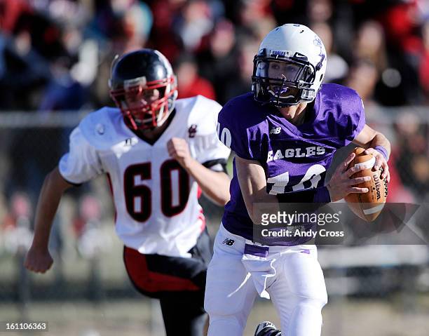 Wray Eagles QB, Brett Vlasin, on a keeper against Landon Harrison and the Burlington Cougars during the Colorado State 1A Championship football game...