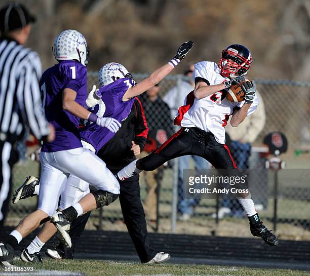 Burlington WR, Coley David, makes a grab against the defense of Justin Fruhwirth, Wray Eagles during the Colorado State 1A Championship football game...
