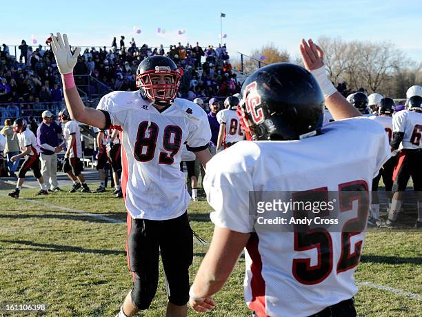 Burlington football players, Luke Prochaska, #89, and Alex Gribben, #52, celebrate their victory against the Wray Eagles for the Colorado State 1A...