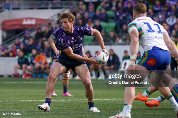 Harry Grant of the Storm passes the ball during the round 24 NRL match between Melbourne Storm and Canberra Raiders at AAMI Park on August 13, 2023...