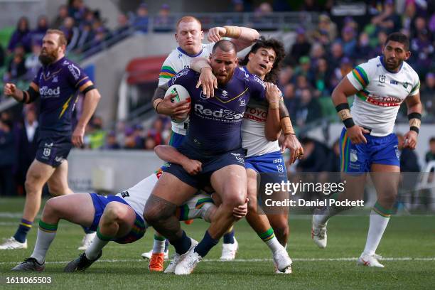 Nelson Asofa-Solomona of the Storm is tackled during the round 24 NRL match between Melbourne Storm and Canberra Raiders at AAMI Park on August 13,...