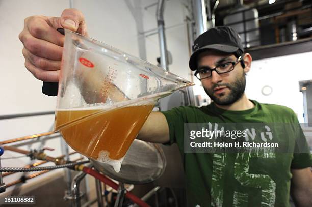 Upslope Brewing Company lead brewer Yazan Karadsheh checks the clarity and color of the beer that he took out of the mash tank. A bill to allow...
