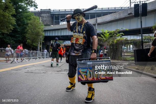 Person holds a boombox and poses at the fiftieth anniversary of Hip Hop block party near 1520 Sedgwick Ave on August 12, 2023 in The Bronx borough of...