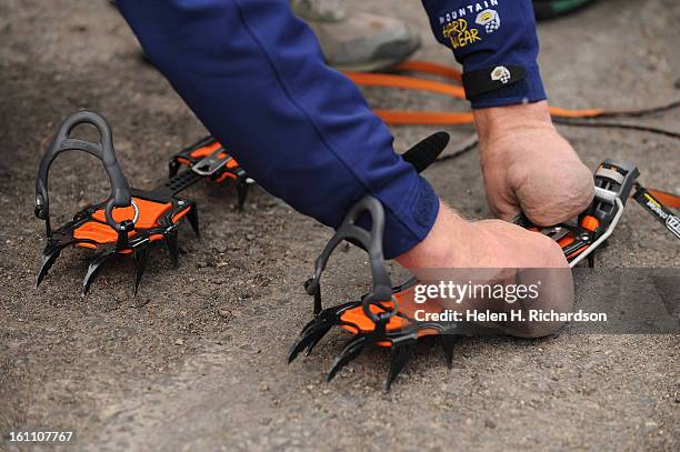 Quinn Simons, who lost all of his fingers and both of his feet to frostbite while climbing in China, gets crampons prepared before heading out for...